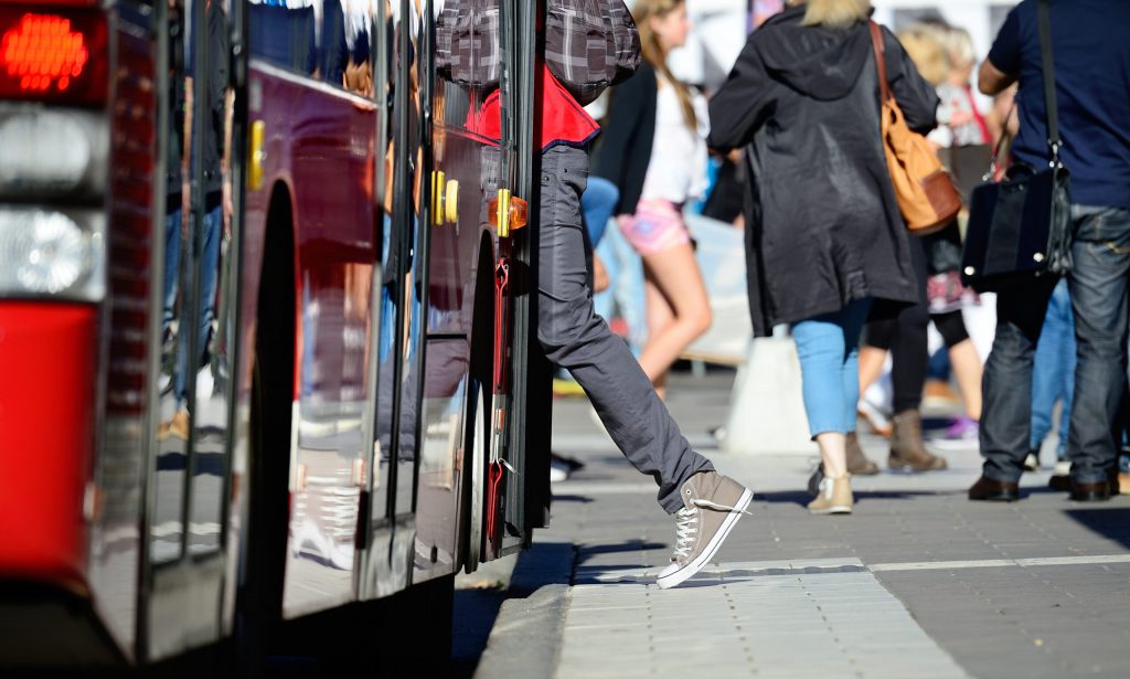 Person enters bus