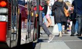 Person enters bus